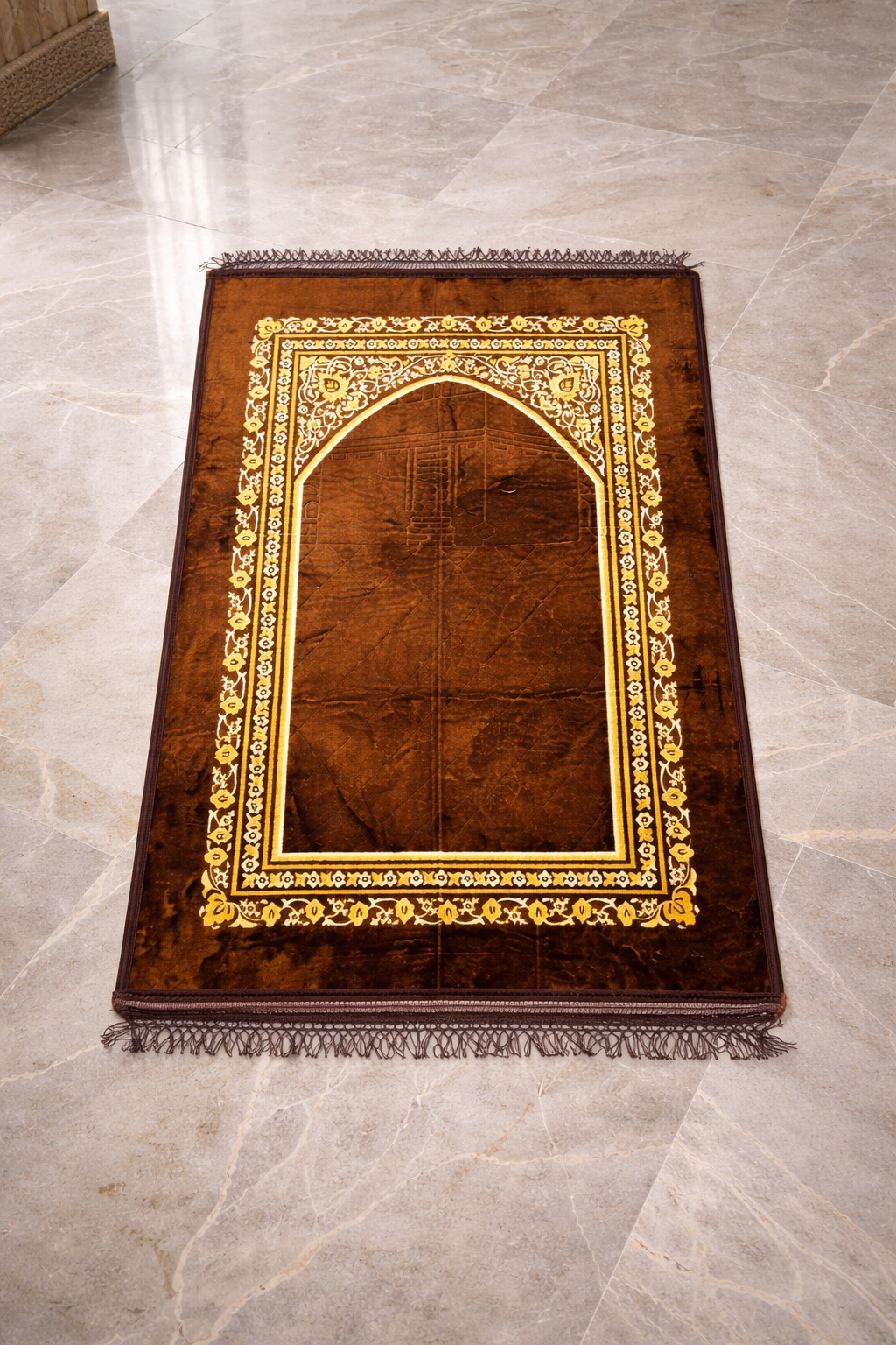 Brown Islamic prayer mat with decorative arch design

