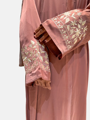 Modern peach abaya for women with delicate white embroidery on sleeves