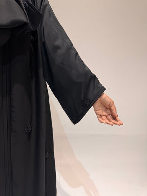 Front-open black abaya with handcrafted bead embellishments and wide sleeves