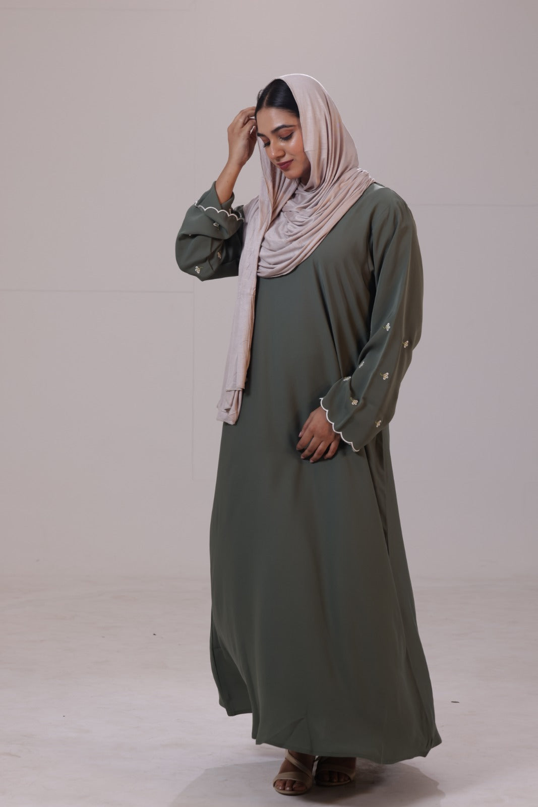 Modest olive abaya with soft nida fabric and subtle embroidered sleeve design