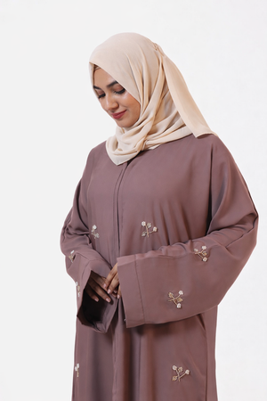 Sophisticated modest abaya featuring artisanal handwork and elegant drape
