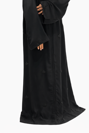 Luxury black abaya featuring all-over beadwork motifs and flowing modest design