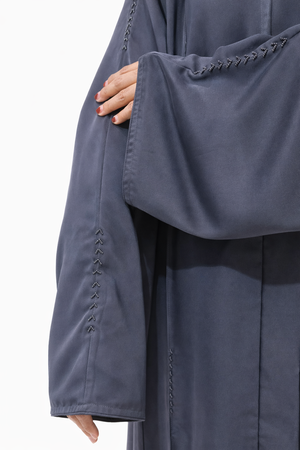 Minimal charcoal grey abaya with vertical stitch design and flowy modest silhouette