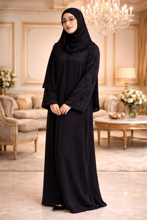 Elegant black abaya with floral embroidered sleeves and flowing modest silhouette